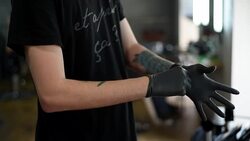 male hairdresser wears gloves in Barbershop Stock Footage