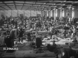 1953: REFUGEES: BERLIN, GERMANY: XWS Refugee camp warehouse. INT VS East Berlin refugees crowded together in skylight warehouse floor, various men, women, children, families, women changing clothes. Berlin Wall, occupied city, privacy Instructional Video