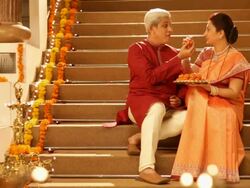 Senior couple eating sweets in diwali festival Stock Footage