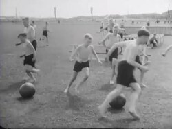 Boys and girls from the Hitler Jugend and the Jeugdstorm sprint against each other in a race Stock Footage