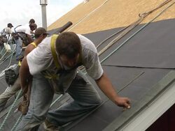 MS SLO MO Shot of five workers on roof / Chelsea, Michigan, United States Stock Footage