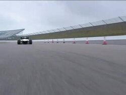Car point of view chasing Formula One race car around track Stock Footage
