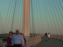 Timelapse of people walking on John Kerry Pedestrian Bridge over Missouri River at sunset Stock Footage