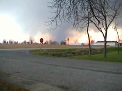 MS ZI ZO Shot of neighbors showing concern as tornado approaching across field in distance / Woodward, Iowa, United States Stock Footage