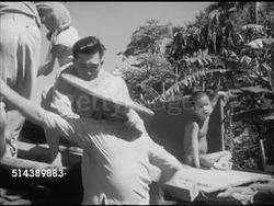 1953: RELOCATION TO NEW VILLAGE: Chinese family squatters loading belongings into truck, children, parents, being moved, relocated to guarded location, better facilities, truck passing through gate, guard FG, WS Unloading. Commonwealth, protection. Instructional Video