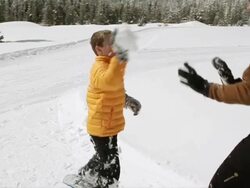 MS PAN SLO MO Young mother and son having fun and snowball fight out on beautiful winter's day / Sun Valley, Idaho, United States Stock Footage