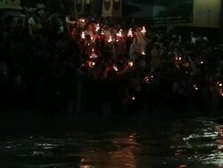 Pilgrims worshipping at riverbank, Ganges River, Haridwar, Uttarakhand, India Stock Footage