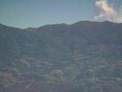"Mountain range and hill with patchwork quilt of fields and forested areas, pans and focuses on purple flower, Amazonas region of Peru [PerÃƒÂº]" Stock Footage