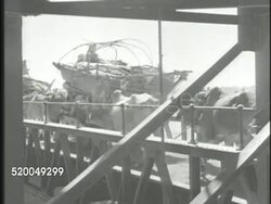 1947: INDO-PAKISTANI CONFLICT: VS Various Muslim refugees migrating w/ carts & cows across bridge. VS Various Hindu refugees w/ carts & families also migrating on road, various Indians walking. Instructional Video