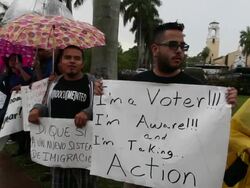 Mid Shot of chanting protesters, pan from right to left, tracking shot of protesters Immigration Activists Protest Outside Of Marco Rubio Fundraiser at Biltmore Hotel on April 05, 2013 in Miami, Florida (Footage by Getty Images)Immigration Activists Protes Stock Footage