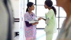 Nurses talking in hospital corridor Stock Footage