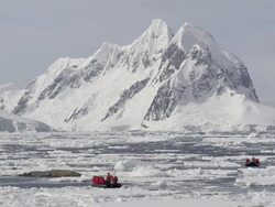 WS View of eco-tourists in zodiac and icebergs in water / Petermann Island, Antarctica Stock Footage
