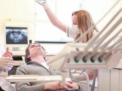 Dental putting on glove to begin. Stock Footage
