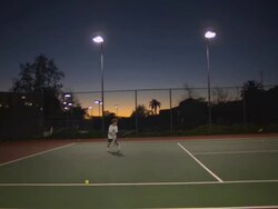 WS, Boy (6-7) playing tennis at dusk, Santa Barbara, California, USA Stock Footage