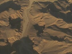 High Angle, tracking-left - Dry riverbeds wind through desert mountains / Egypt Stock Footage