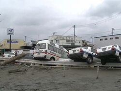 Destruction caused by tsunami after magnitude 9 Tohoku earthquake, north east Japan, March 2011. Cars lie piled in thick mud after tsunami in Ishinomaki City,  Miyagi Prefecture Stock Footage
