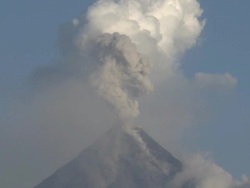 Large ash explosion rises into the sky above Mayon volcano overlooking Legazpi city, Philippines, December 2009 Stock Footage