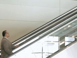 LA Businessman riding up escalator / Seattle, Washington, United States Stock Footage