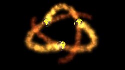 Three miniature golden globes spiral around in the shape of an atom. Stock Footage