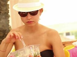A young girl eating in a beach bar Stock Footage