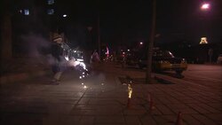 A little boy watches a fountain of sparks on a Beijing street. Stock Footage