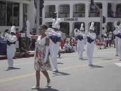 An attractive young woman in leads a stylish marching band. Stock Footage