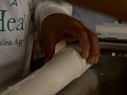 Employee cuts palm tree logs into segments using knifes and saws. Stock Footage