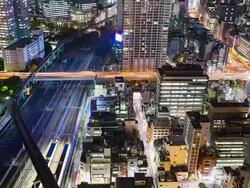 WS T/L View of elevated highway and train traffic in hamamatsucho at night / Tokyo, Japan Stock Footage