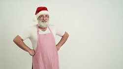 Adult senior man showing a copy space in the Santa Claus hat on a grey background Stock Footage