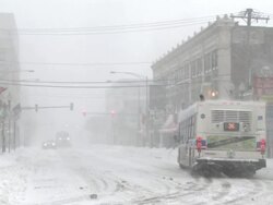 WS View of turning bus at city street during blizzard / Chicago, Illinois, USA Stock Footage