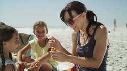 Daughter applying sunscreen to mother's nose Stock Footage