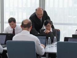 HD DOLLY: Manager Assisting Office Team Stock Footage