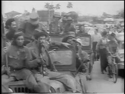 B/W 1959 PAN Fidel Castro smoking cigar rides in off-road vehicle with other soldiers / post-revolution Havana Stock Footage