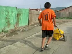 MS POV Mongolian boy taking water home / Ulaan Baatar, Tuv, Mongolia Stock Footage