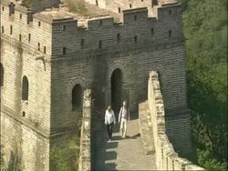 Tourists walking out from watch tower and along Great Wall of China, Mutianyu, China Stock Footage