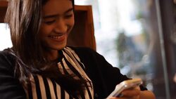 asian girl is smiling while chatting by smart phone Stock Footage