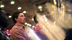 Young guy wins big at casino slot machine, kisses young woman and celebrates with friends Stock Footage