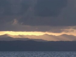 WS Ocean and mountains under setting sun / Great Barrier Reef, Australia  Stock Footage