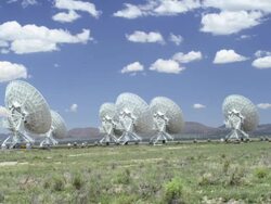 Very Large Array Radio Telescopes near Socorro, New Mexico, USA. T/L fluffy clouds Stock Footage