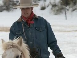 CU Cowgirl on horseback cantering through snowy field / Shell, Wyoming, United States Stock Footage