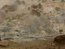 MS Water bubbling from geothermal hot spot surrounded by orange rocks and steam in Krysuvik Geothermal area / Reykjanes peninsula, Iceland        Stock Footage