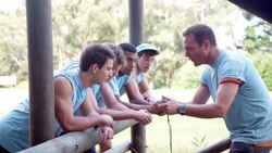 Team leader motivating team at boot camp obstacle course Stock Footage