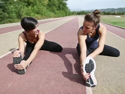 Stretching and chatting athletes Stock Footage