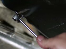 CU Mechanics tightening nut with wrench on oil pan / Bergenfield, , New Jersey, USA    Stock Footage