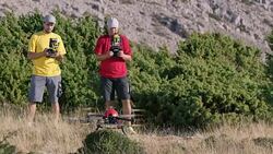 PAN Two men lifting the drone into air in sunshine Stock Footage