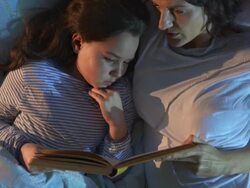 HD CRANE: Mother Reading A Bed Time Story Stock Footage