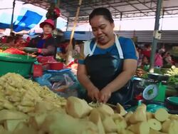 MS POV SLO MO Woman vendor cutting vegetables in market / Vientiane, Laos Stock Footage