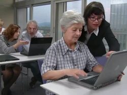 HD: Lecturer Helping Seniors Using Computer Stock Footage