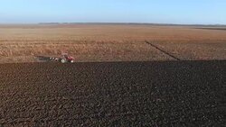 Tractor plowing on a farm field Stock Footage