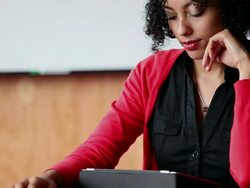 MS PAN TD  Businesswoman sitting at office conference table working on digital tablet/Washington, USA Stock Footage